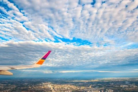 Plane wing, white clouds and blue sky Stock Photos