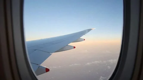 Plane wings window view in day sky Stock Footage 296277551