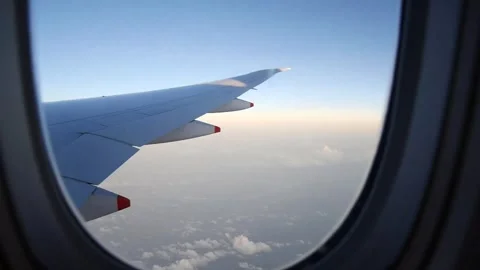 Plane wings window view in day sky Stock Footage 296277554