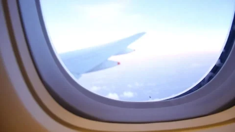Plane wings window view in day sky Stock Footage 296277555
