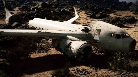 Plane wreckage in a desolate area after a crash near rocky terrain Stock Footage 313436204