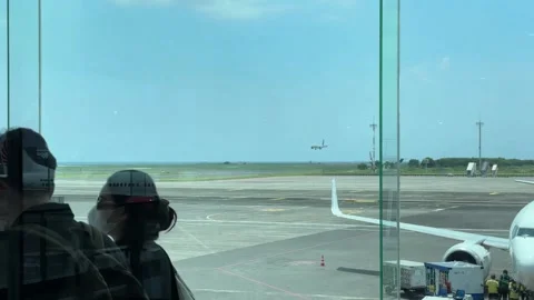 Planes arrive and depart at I Gusti Ngurah Rai International Airport in Bali. Stock Footage 320810700