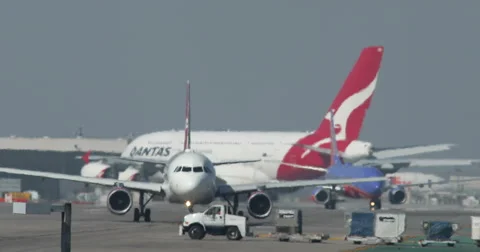 Planes Crossing while Taxiing at LAX International Airport Stock Footage 55276751