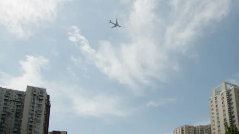 Planes flying across the skyline seen from distant buildings Stock Footage 273666185