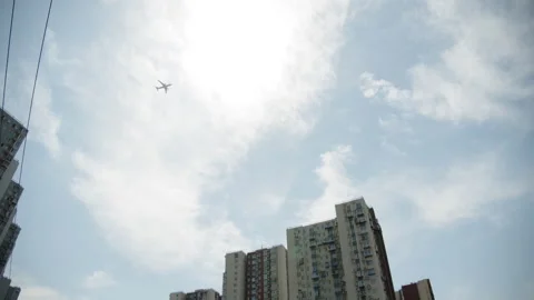 Planes flying across the skyline seen from distant buildings Stock Footage 273666900