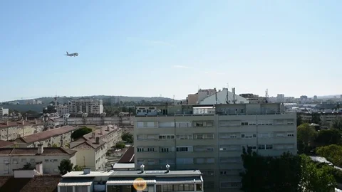 Planes flying really close to city centre buildings and houses Stock Footage 118666948