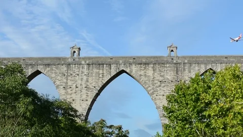 Planes flying really close to city centre, frame with ancient roman aqueduct in Stock Footage 118666991