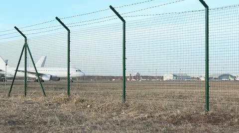 Planes landing behind plane parking in airport Stock Footage