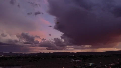 Planes landing Dramatic Purple Sky Over Mountain Peaks Outside Las Vegas Stock Footage 344906803
