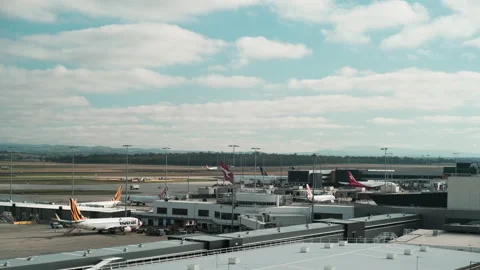Planes Parked At Melbourne Airport Terminal With Qantas Jet Taking Off Stock Footage 238413789
