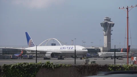 Planes on the runway moving around at LAX Stock Footage 89186253