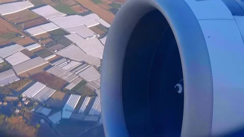 From the plane's windows you can see many warehouse buildings Video stock 323855150