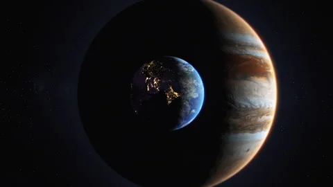 Planet earth in comparison to the large size of the planet Jupiter.Solar system  Stock Footage 229968217