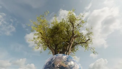 Planet earth with a growing tree and blue sky background with white clouds. Last Stock Footage 246473550
