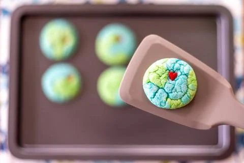 Planet Earth shaped cookie on a spatula Stock Photos