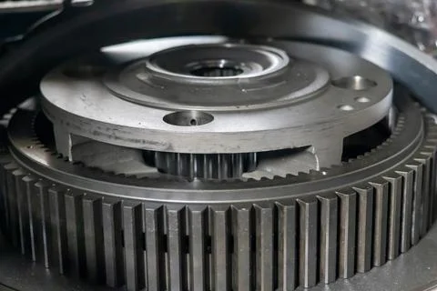 Planetary gear assembly with internal ring gear rests on table in transmiss.. Stock Photos
