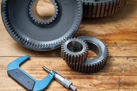 Planetary Gear Set and Precision Micrometer on Workshop Table. Stock Photos