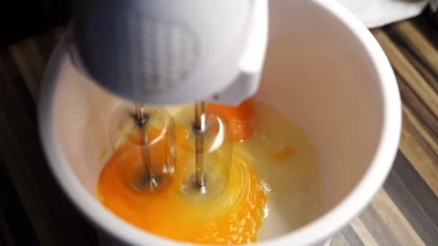 Planetary mixer beats raw eggs with sugar in a deep bowl on the table Stock Footage 269734817