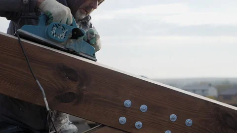Planing a tree with an electric planer. Human emotion. Hard work. Stock-Footage 149990175