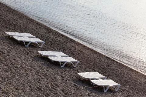 Plank bed on a pebble beach on the seashore Stock Photos