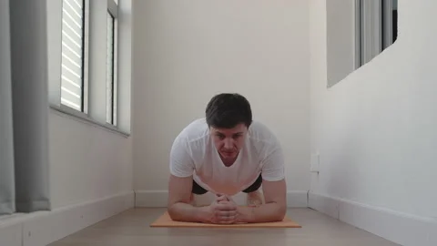 Plank exercise at home. Young man training alone on balcony. Stock Footage 130296330