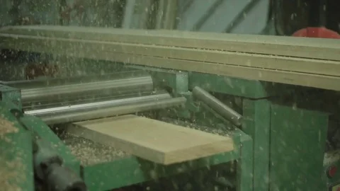 Plank on woodwork machine make sawdust. slow motion carpenter cutting wood Stock Footage 77672574