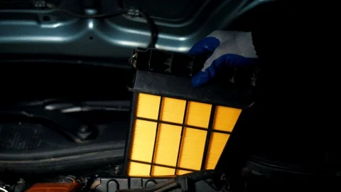 Planned replacement of the air filter of the car with a new yellow color Stock Footage 102683149