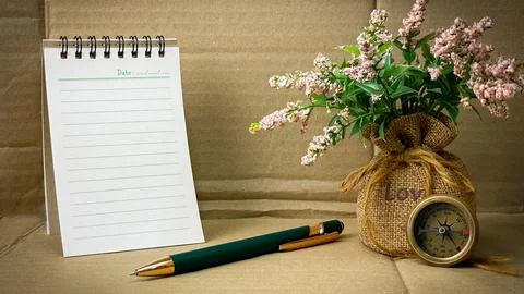 Planner and notebook with a pen, compass, and floral design Stock Photos