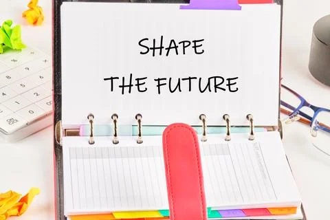 A planner displays the text 'SHAPE THE FUTURE' emphasizing the importance of  Foto stock