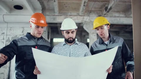 Planner engineer at a construction site. Male in helmets and protective suit Stock Footage 130776933
