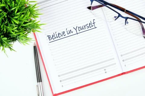 A planner opened to a page with an uplifting phrase, inviting readers to em.. Stock Photos