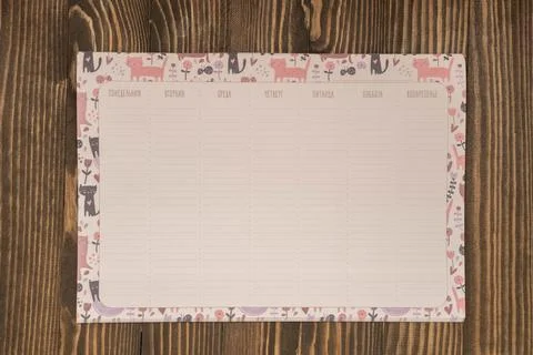 Planner of the week on a wooden background, the concept is coming to school soon Stock Photos