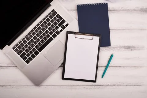 Planner on the wooden working table with computer. Blank white paper on working Stock Photos