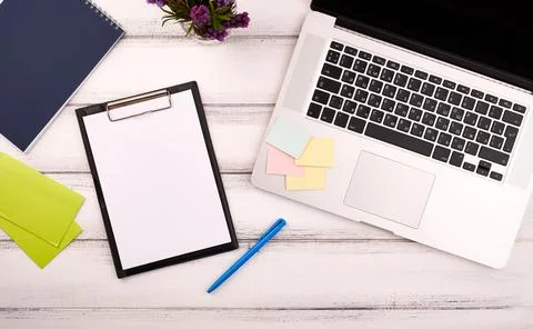Planner on the wooden working table with computer. Blank white paper on working Foto stock