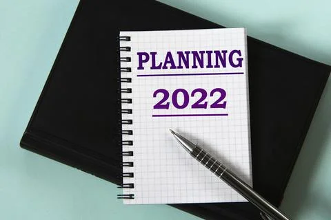PLANNING 2022 - words in a white notebook against the background of a black n Stock Photos