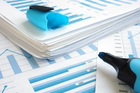Planning business strategy. Stack of papers with financial graphs. Stock Photos