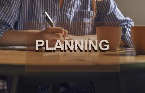 Planning concept. Writing notes, plans in notebook on wooden table with coffe Stock Photos