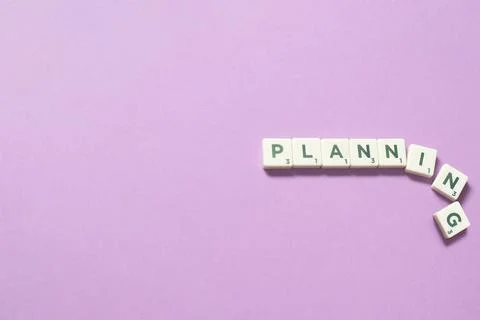 Planning formed of scrabble blocks on lilac background. Stock-Fotos