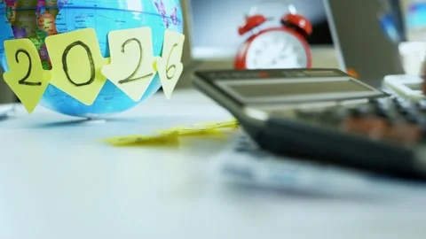 Planning for the future in 2026, Globe with a sticky note displaying the ye.. Stock Footage 321936863