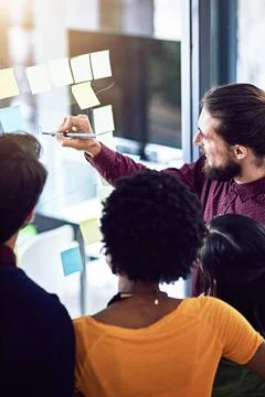 Planning helps you avoid costly errors. a group of businesspeople working on a Foto stock