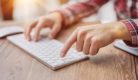 Planning his work process, taking notes and using laptop. cropped image Foto stock