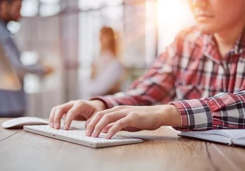 Planning his work process, taking notes and using laptop. cropped image Foto stock