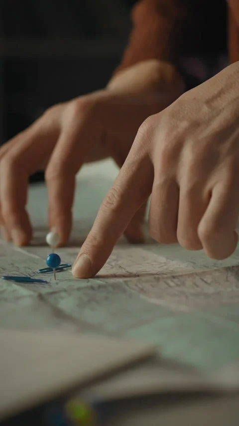 Planning a journey with a detailed map and colorful pins at home Stock Footage 331678727