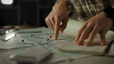 Planning a navigation route with maps and markers at a workspace Stock Footage 304270408