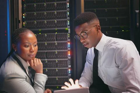 Planning, team or engineer with tablet in server room, troubleshooting or review Stock Photos