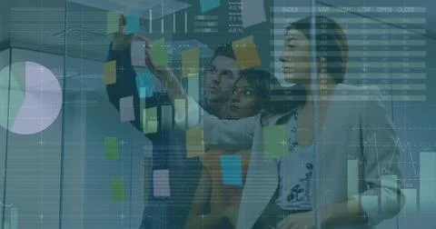 Planning team placing sticky notes on office glass partition in business attire, Stock Photos