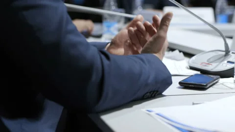 Planning of teamwork idea indoors. Director sitting at table and explaining at c Stock Footage 199475255