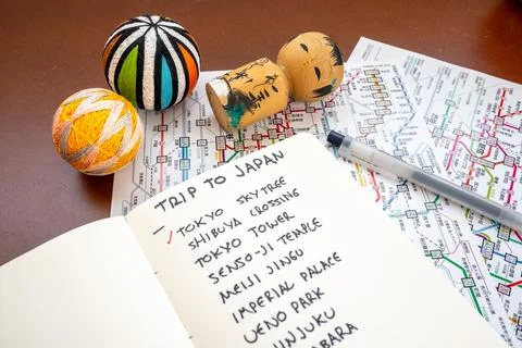 Planning a tokyo vacation itinerary using a map and notebook Stock Photos