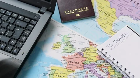 Planning travel concept with a notebook a passport and a laptop maps Stock Footage 340583473