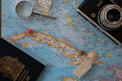 Planning a trip to Cuba with a world map and accessories. Stock Photos
